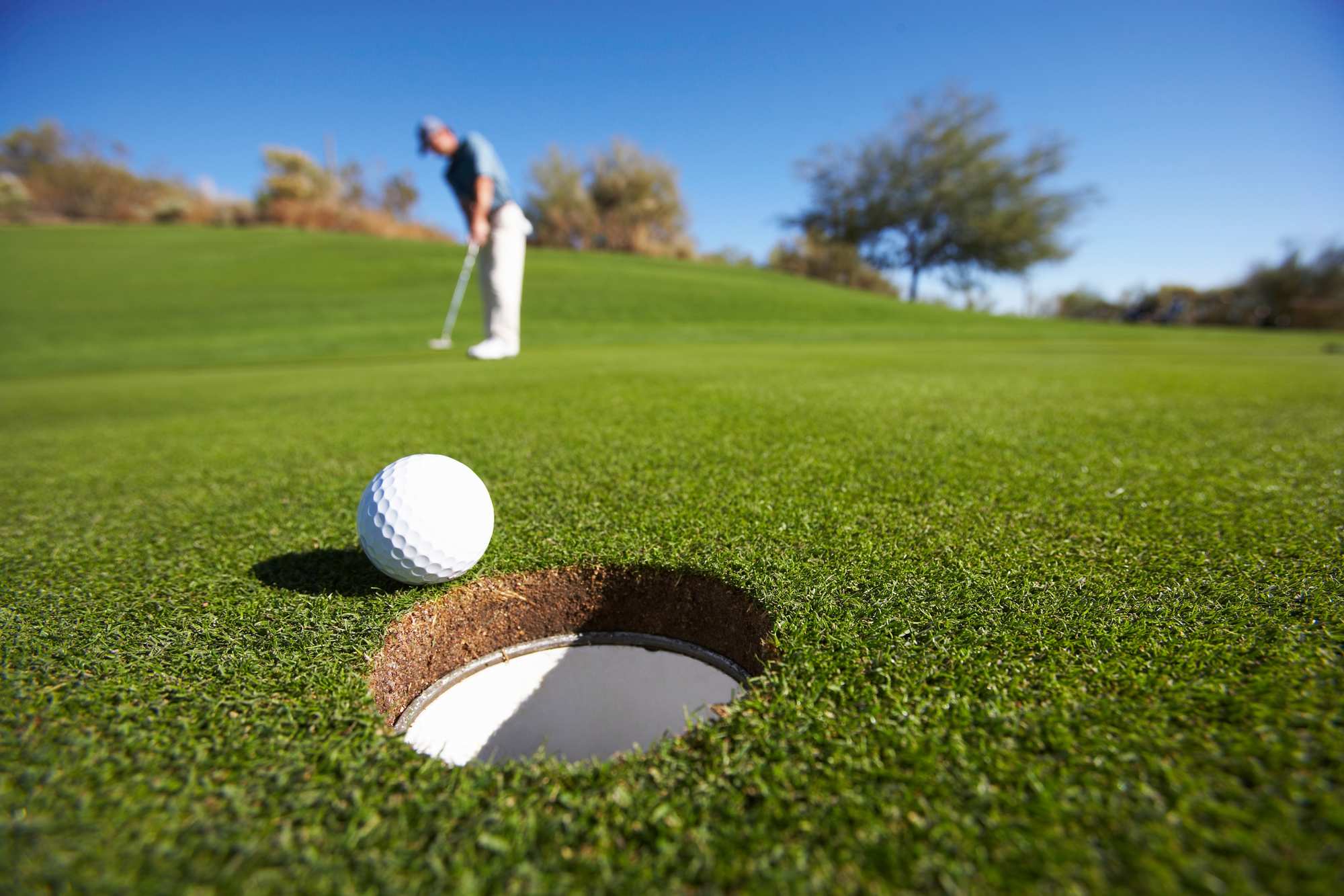 A golf ball rolling to the hole