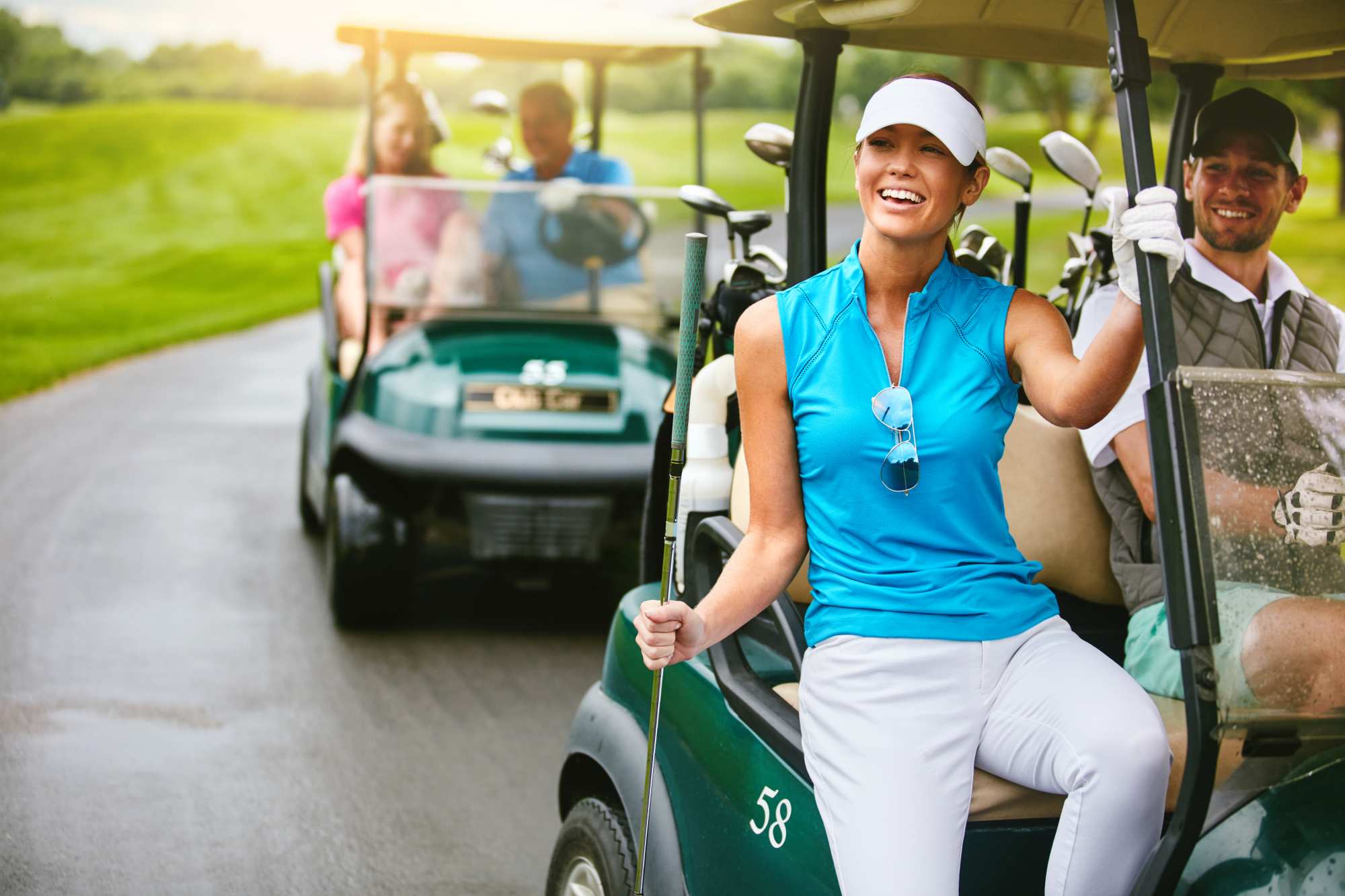 A woman riding a golf car